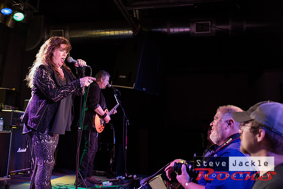 Stacey Winn:  vocals pointing out  a photographer in the crowd.